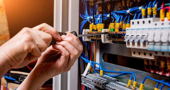 Professional electrical work - technician working on electrical panel
